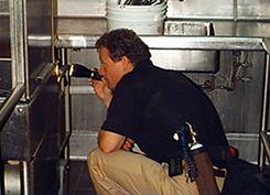 Pest Management Professional inspecting a commercial dishwasher